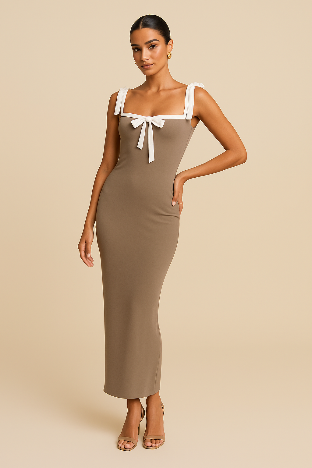 Woman wearing a beige dress with white bow straps against a beige background